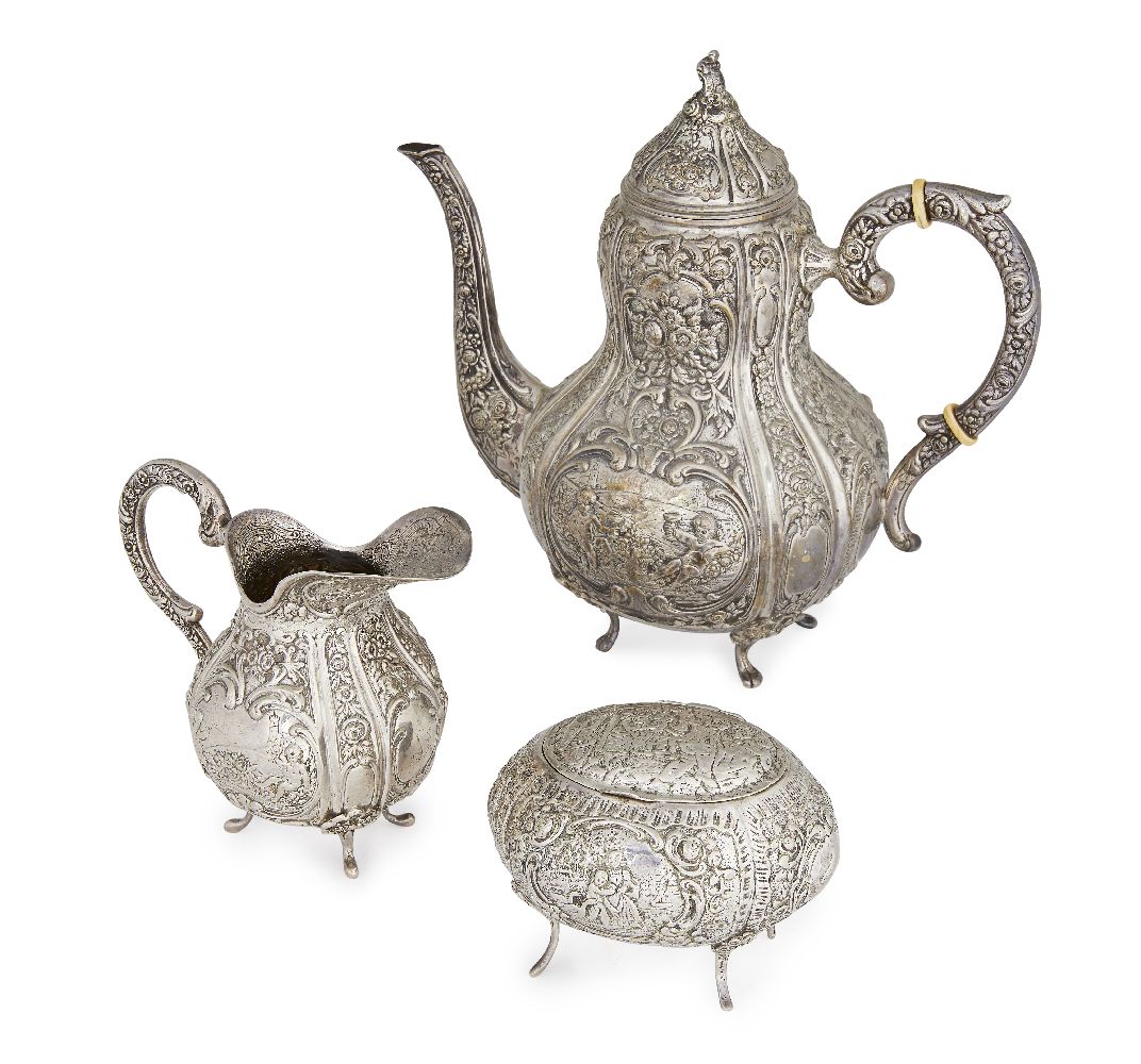 A Danish silver coffee pot and cream jug, early 20th century, in the rococo style with repousse
