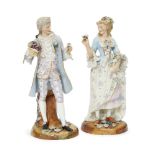 A pair of Continental porcelain figures of a lady and gentleman, early/mid 20th century, she dressed