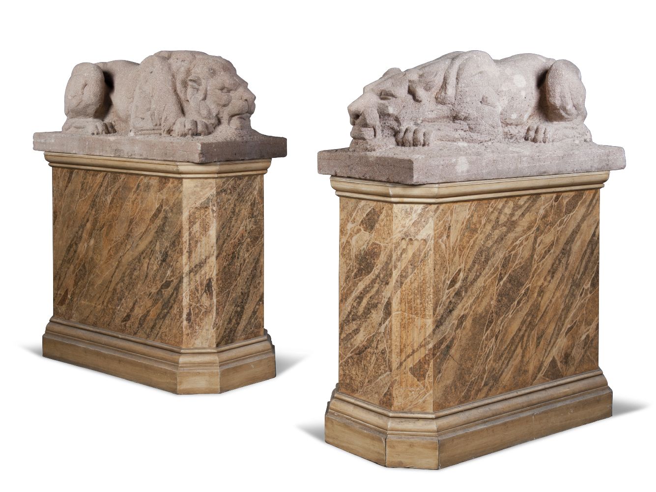 A pair of sandstone models of a lion and lioness, 20th century, modelled with integral bases, on