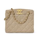 Chanel: a quilted buff coloured fabric bag, with two internal zippered wall pockets, gold plated