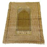 A Prayer rug, early 20th century, with ochre coloured prayer panel, surrounded by multiple guard