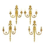 A set of four Louis XVI style gilt bronze twin-light wall appliques, 20th century, the backplates