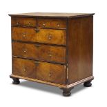 A William and Mary walnut and line inlaid chest of drawers, the quarter veneered top with inlaid