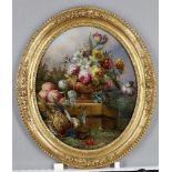 A late Victorian reverse painted oval picture on glass, depicting flowers in an urn with a dead