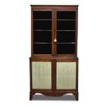 A Regency mahogany bookcase, the moulded cornice above two glazed doors, enclosing three shelves,