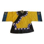 A Chinese yellow silk brocade jacket, late Qing dynasty, with floral embroidered sleeves, and