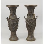 A pair of Japanese bronze vases, late 19th/early 20th century, modelled to the exterior with