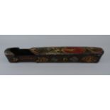 A large papier mache and lacquered qalamdan/ pen box,19th century, decorated to the sliding lid with