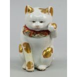 A Japanese pottery model of a seated cat, late 19th/early 20th century, enriched with gilt