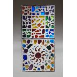 A decorative concrete and coloured glass panel, c.1970, of rectangular form, with coloured glass sun