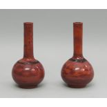 A pair of Chinese Peking glass red ochre bottle vases, 20th century, 23cm high (2)Please refer to