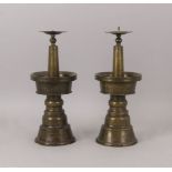 A pair of Syrian bronze pricket sticks, 18th/19th century, 30cm high (2)Please refer to department