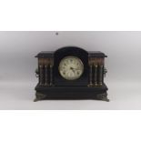 A Victorian simulated black slate mantel clock, late 19th/early 20th century, the case of