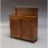 A Regency rosewood and brass inlaid chiffonier, the top shelf with pierced brass gallery, on