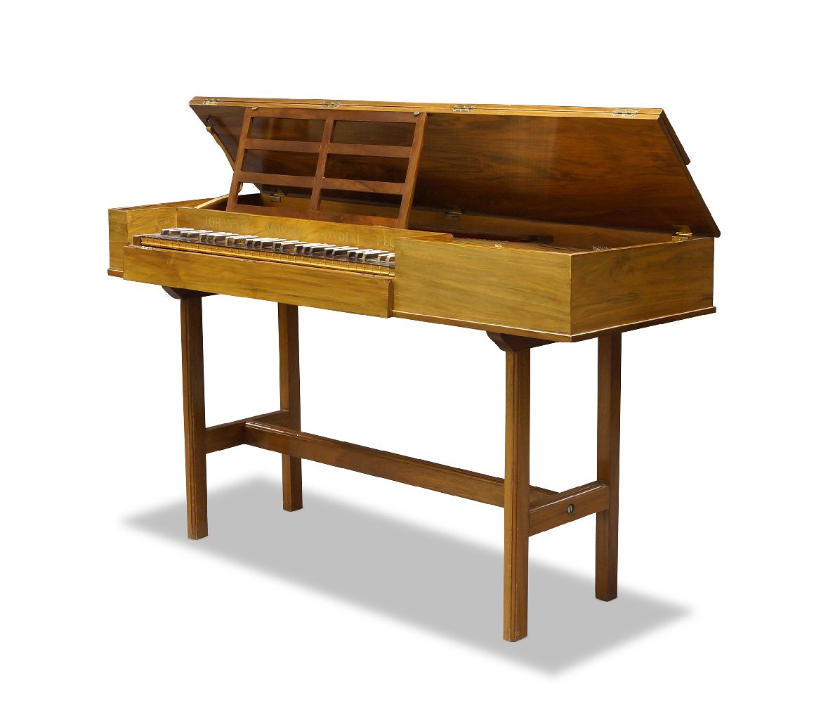 A walnut 5 octave clavichord on stand by John Morley, London, of rectangular form with lifting