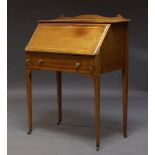 An Edwardian mahogany and inlaid bureau, with shaped raised back, above fall front enclosing two