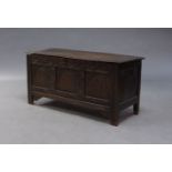 An oak coffer, 17th Century, the hinged lid, enclosing storage compartment and candle box, the