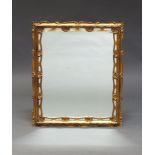 A giltwood wall mirror, early 20th Century, of rectangular form, with scallop shell decoration, 68cm
