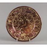 A Hispanio Moresque pottery plate, 19th century, gilded with a bird within scrolling foliage, 20.5cm