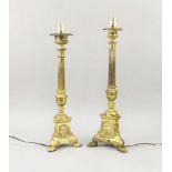 A pair of Continental brass pricket sticks, late 19th century, converted to electricity, the three