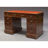 An Edwardian mahogany pedestal desk, the rectangular top, inset with red leather writing surface,
