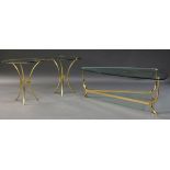 A Pair of brass and glass side tables by Valenti, c.1970, the circular glass top on curved tripod