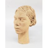 A terracotta portrait bust of a girl, 20th century, modelled with swept back hair, with a slender