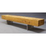 A large modern pine bench, late 20th Century, the rectangular block seat raised on steel supports,