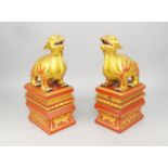A pair of painted and gilt hardstone Chinese turtle dragons, of recent manufacture, modelled resting