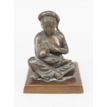A bronze figure of an Asian woman feeding her baby, late 19th/early 20th century, modelled seated