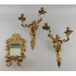 A pair of French gilt metal twin branch wall lights, in the Louis XV taste, late 19th/early 20th