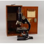 A Cooke, Troughton and Sims microscope, mid 20th century, with various lenses, , in a mahogany
