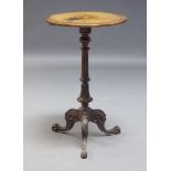 A Victorian walnut and marquetry inlaid occasional table, the circular top inlaid with scroll work
