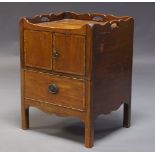 A George III mahogany and inlaid commode cupboard, the shaped gallery with pierced handles, above