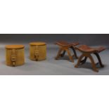 Pierre Lottier, a pair of 'slipper' foot stools, c.1940/50, the tan leather seats on curved x-