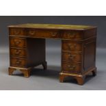 An Edwardian mahogany pedestal desk, the rectangular top inset with green leather writing surface,