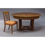 A mahogany and inlaid extending dining table, first half 20th Century, the circular table top,