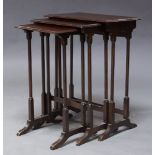 A mahogany nest of three tables, early 20th Century, the rectangular tops, raised on twin column end