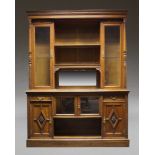 A Large carved oak and glazed triple cabinet, early 20th Century, the dentil moulded cornice above