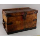 A brown leather and metal bound rectangular travelling trunk, 20th century, with two heavy handles