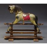 A painted wood rocking horse, early to mid 20th Century, with horse hair mane, leather bridle and