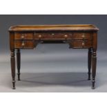 A Regency mahogany desk, the rectangular top with raised three quarter gallery, above five