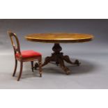 A Victorian walnut tilt top loo table, the oval top, on baluster form support, to floral carved legs