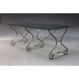 A large French wrought steel and glass dining table, late 20th Century, the rectangular glass top on