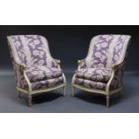A pair of white painted bergere armchairs, in the Louis XVI taste, second half 20th Century, the