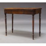 A George IV mahogany card table, the fold over top enclosing green baize lined playing surface,