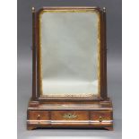 A George III mahogany dressing table mirror, the arched swing frame with gilt slip, above three base