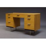 John and Sylvia Reid, a kneehole desk for stag, c.1960, with an arrangement of seven drawers, raised