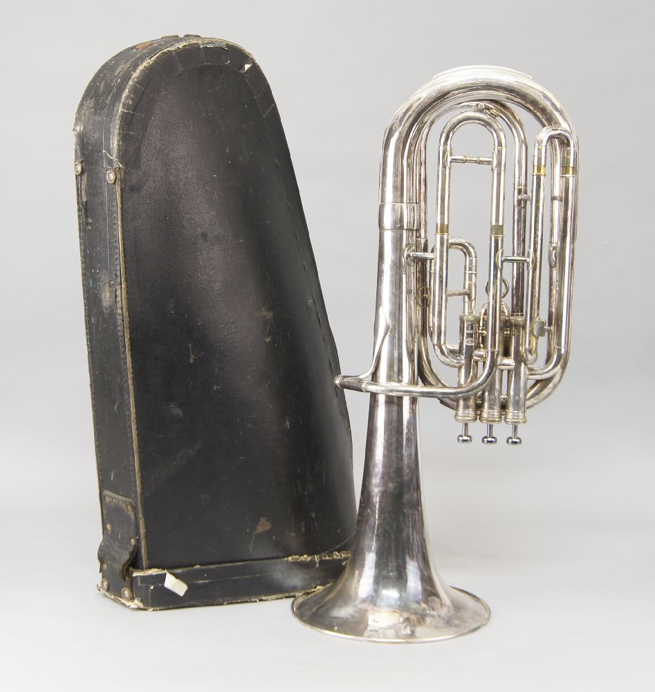 A silvered metal Besson horn, in a case, lacking mouthpiece, 64cm highPlease refer to department for