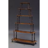 A Victorian rosewood six-tier whatnot, with six graduated shaped shelves on spiral supports,